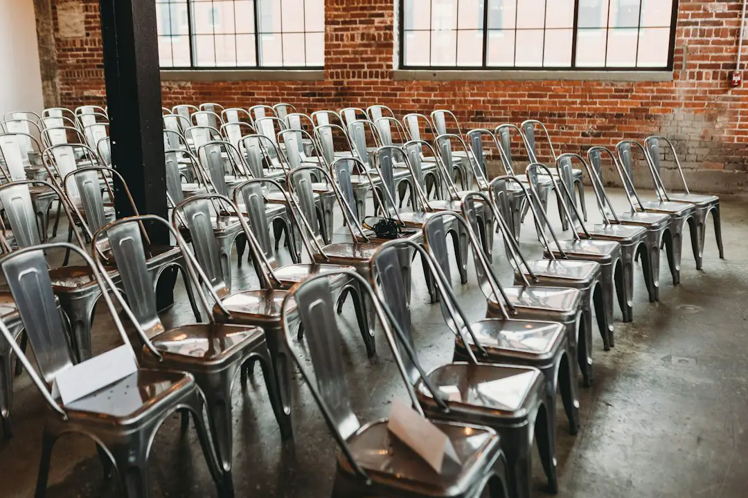 a room filled with lots of metal chairs