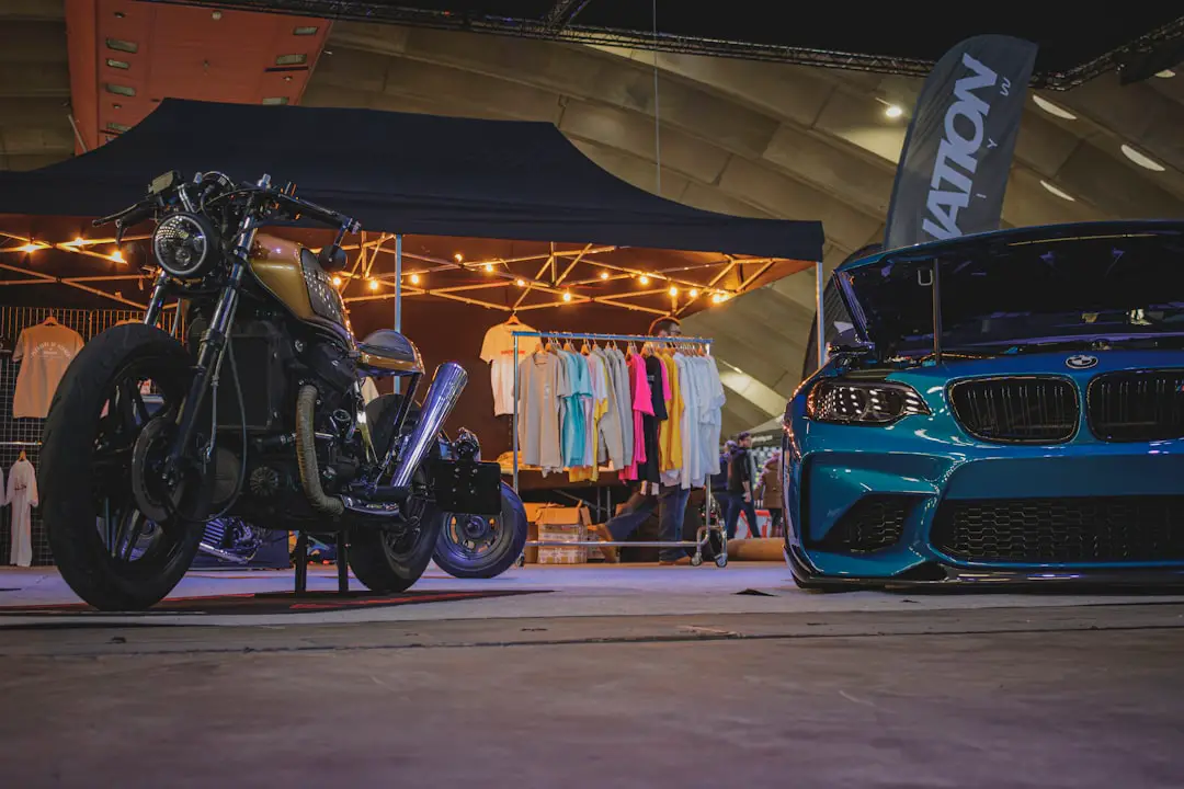 a blue motorcycle parked next to a blue car