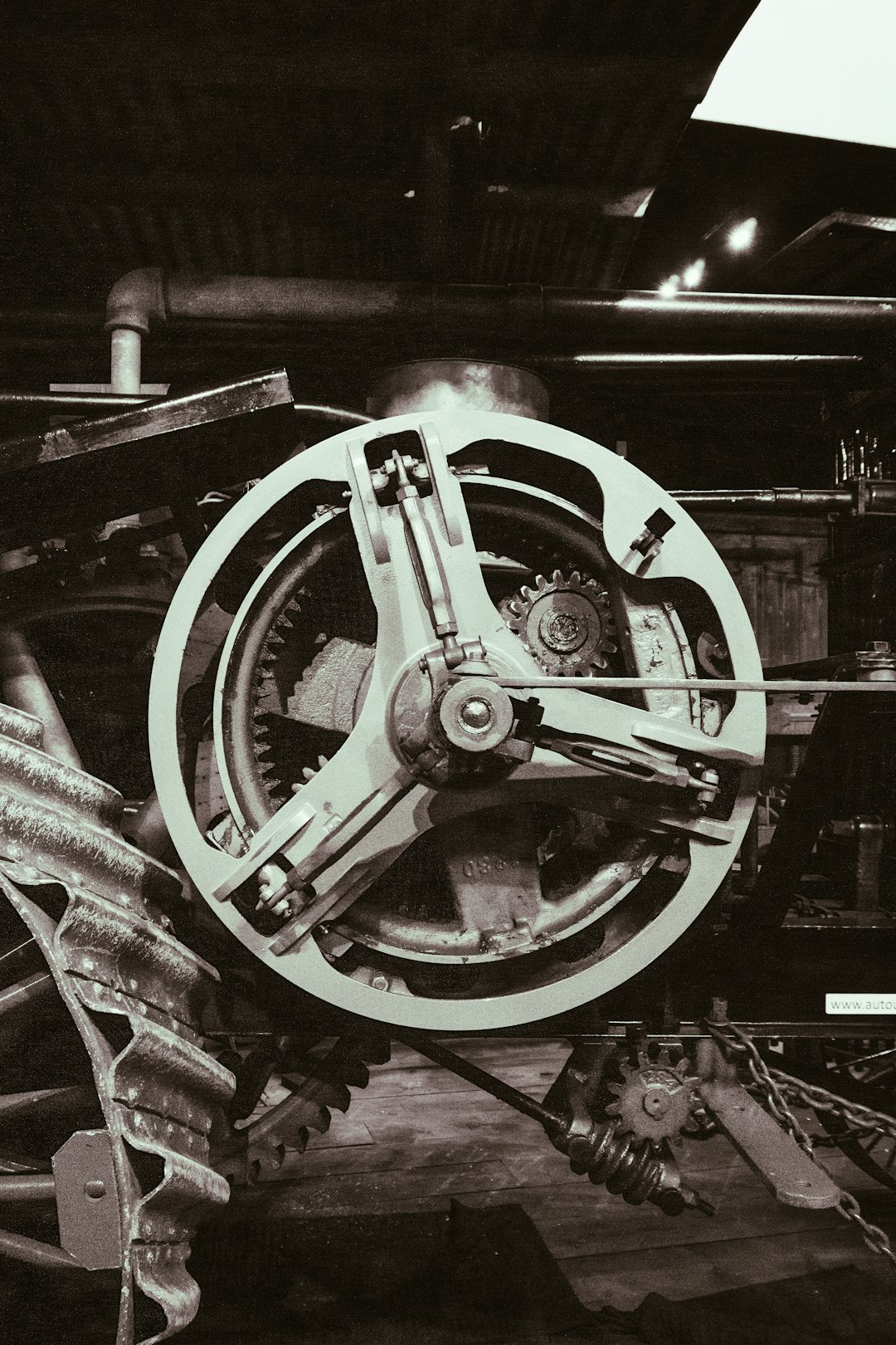 a black and white photo of a train wheel