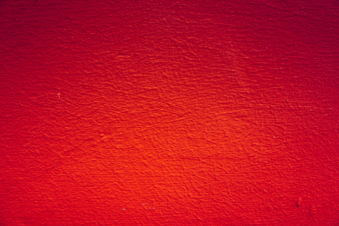 red painted wall in close up photography