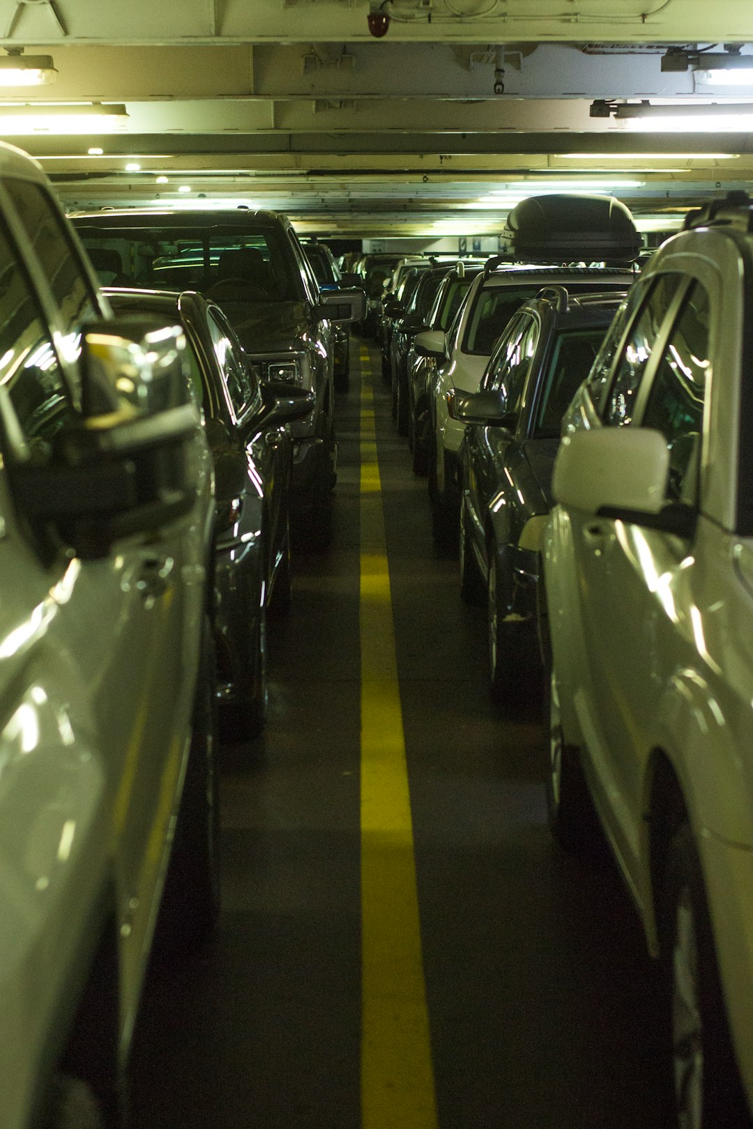 a line of cars parked in a parking garage