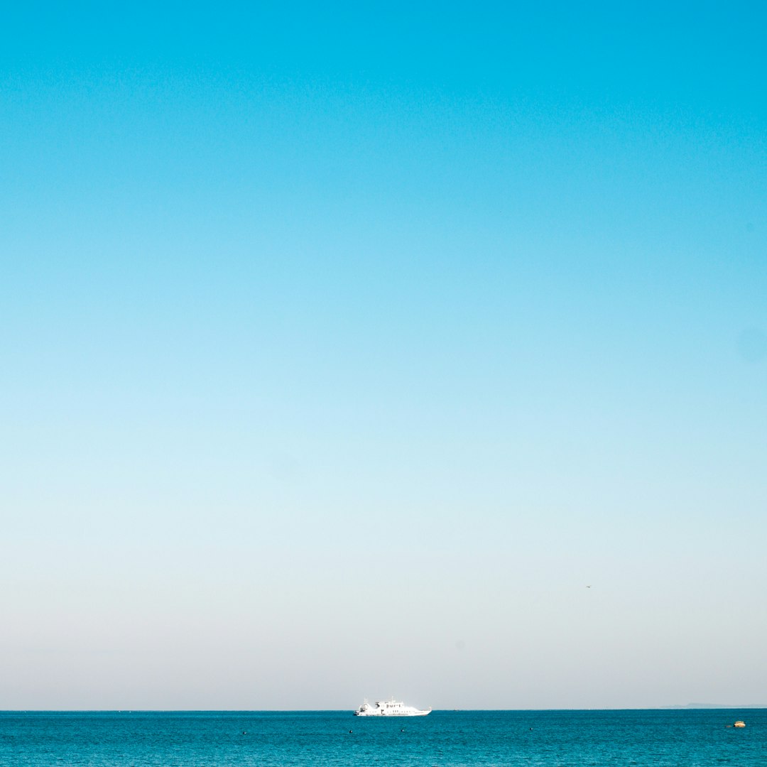 a boat is out in the ocean on a clear day