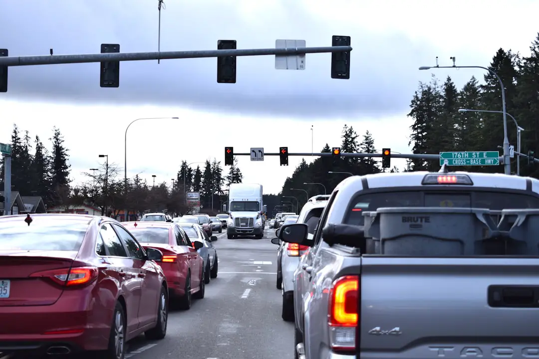 a street filled with lots of traffic under a traffic light