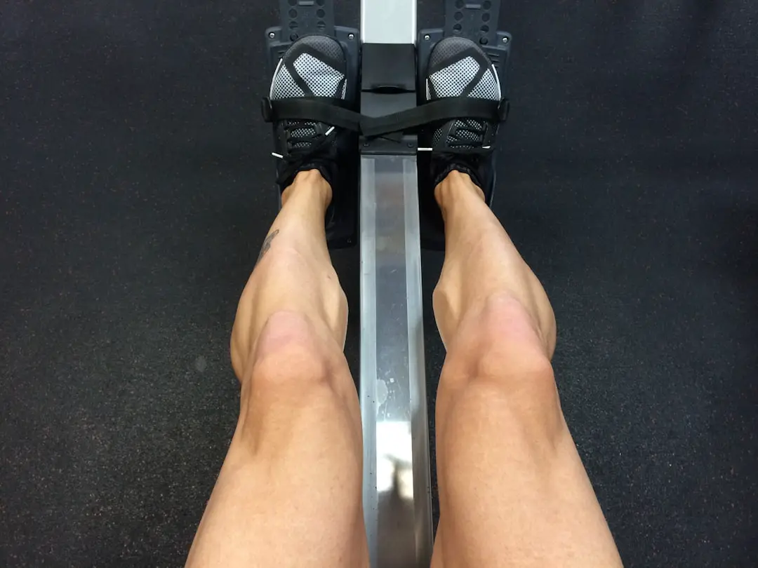 person sitting on rowing machine