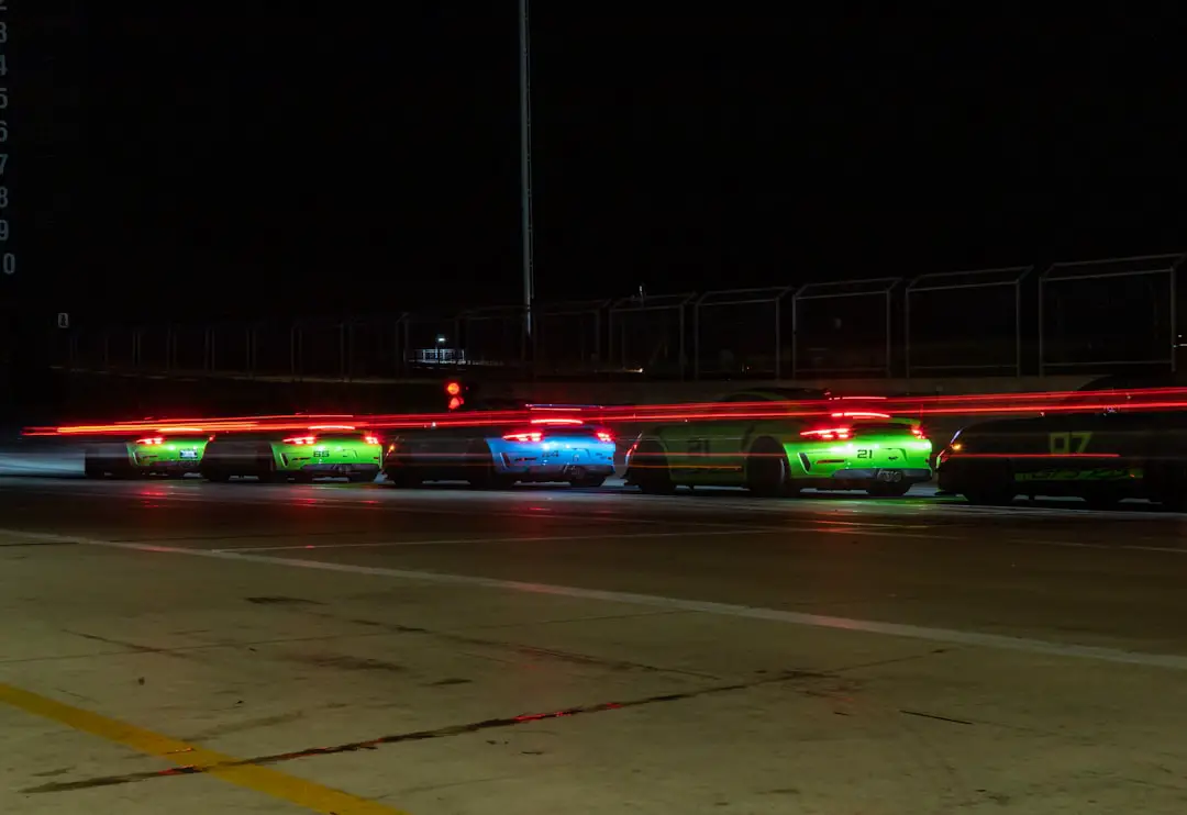 green and red car on road during night time