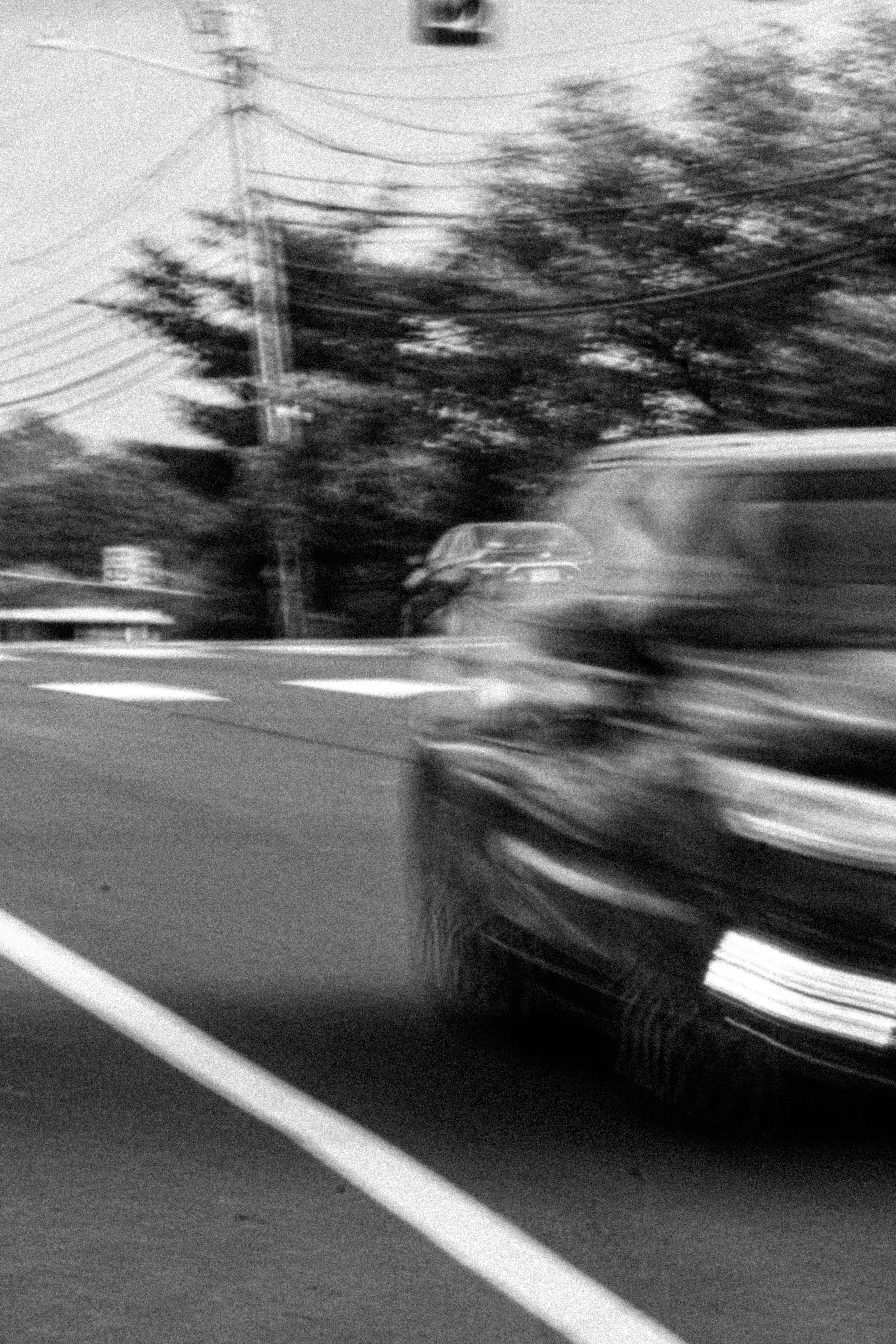 a blurry photo of a car driving down a street