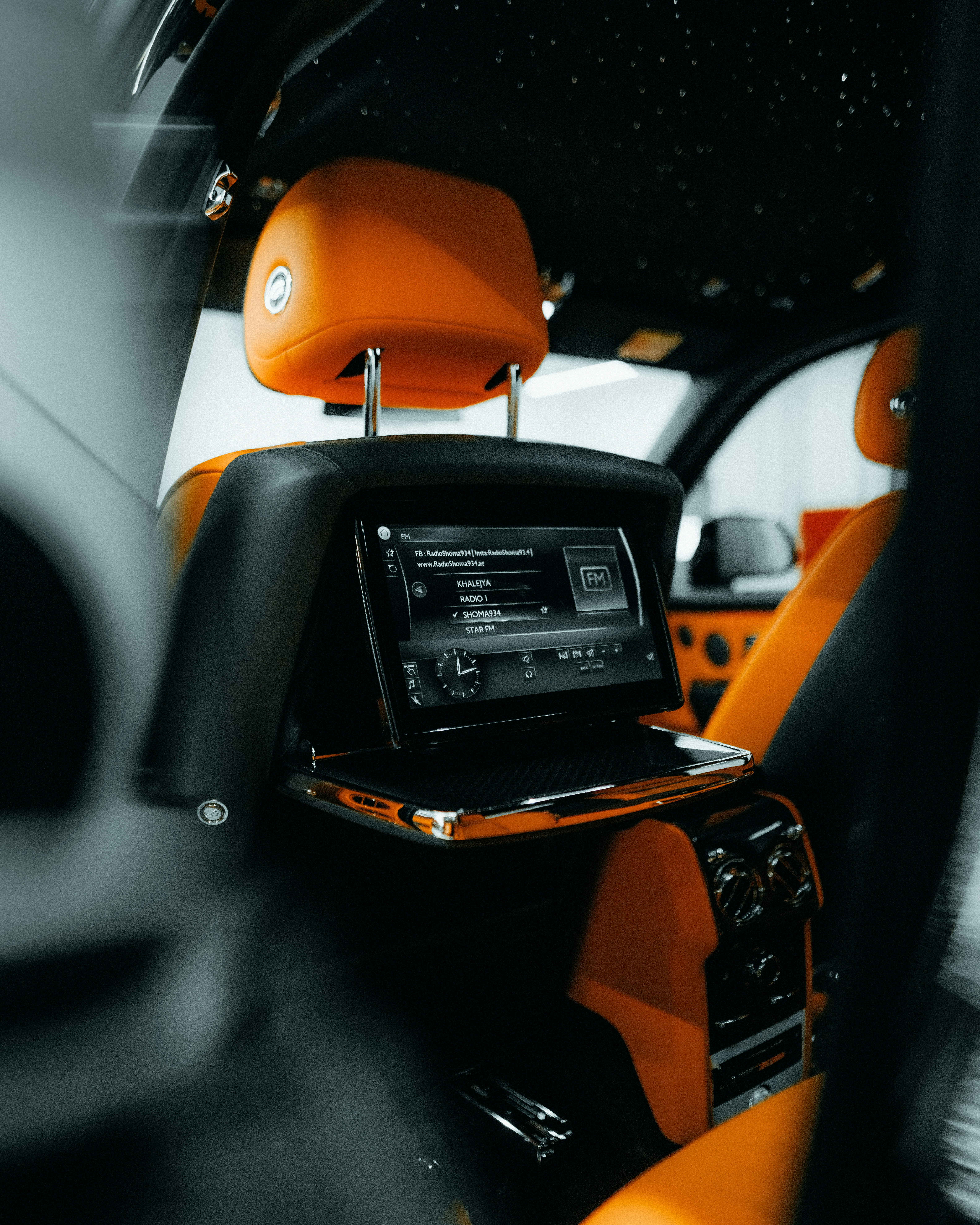 the interior of a car with orange and black trim